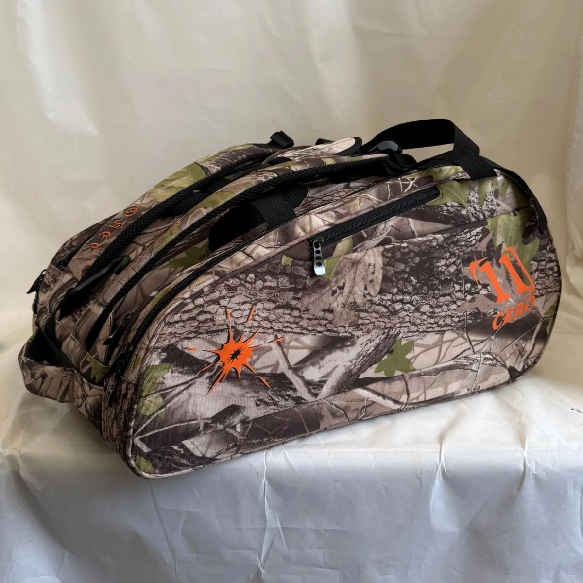Recon Cero Bag in camo, side view with orange 11 Cero logo